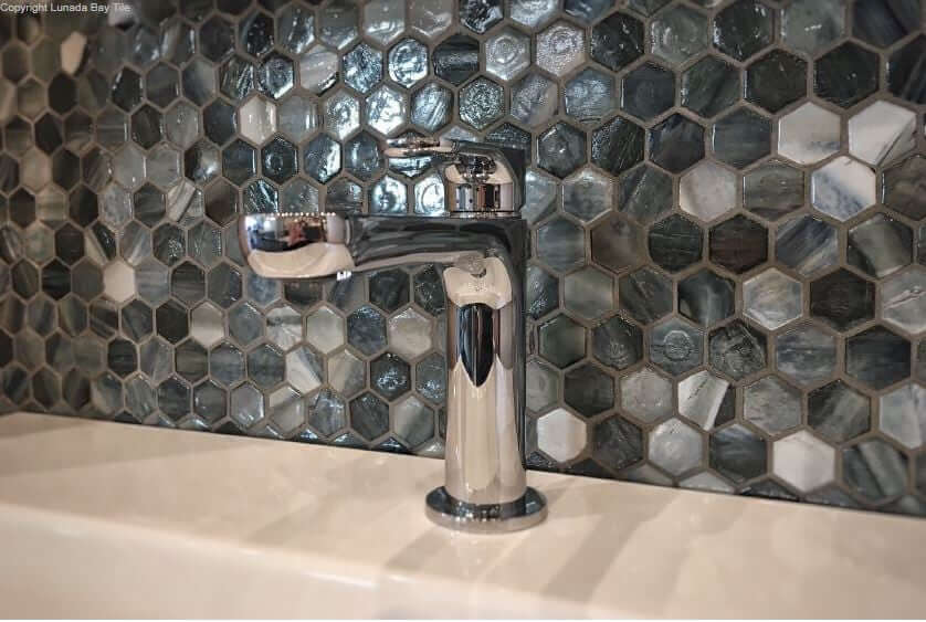 Glass mosaic tiles on a bathroom backsplash 