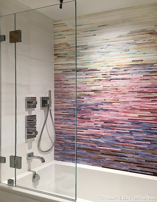 Colorful ombre design tiles make this shower a vibrant space.