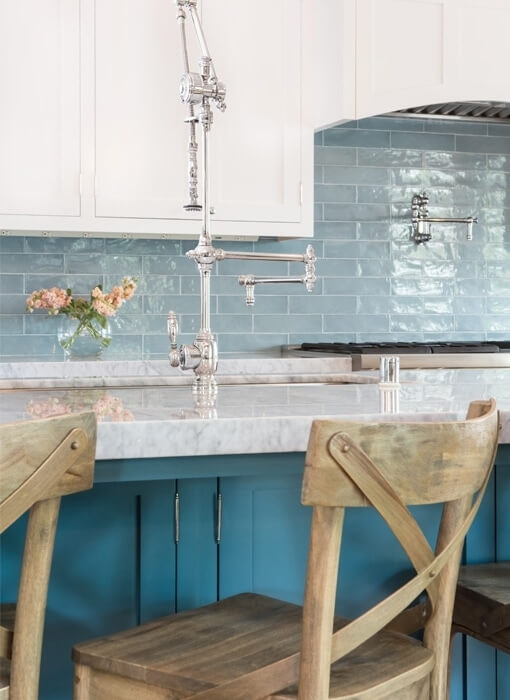 Bright teal cabinets with a soft blue tile backsplash 