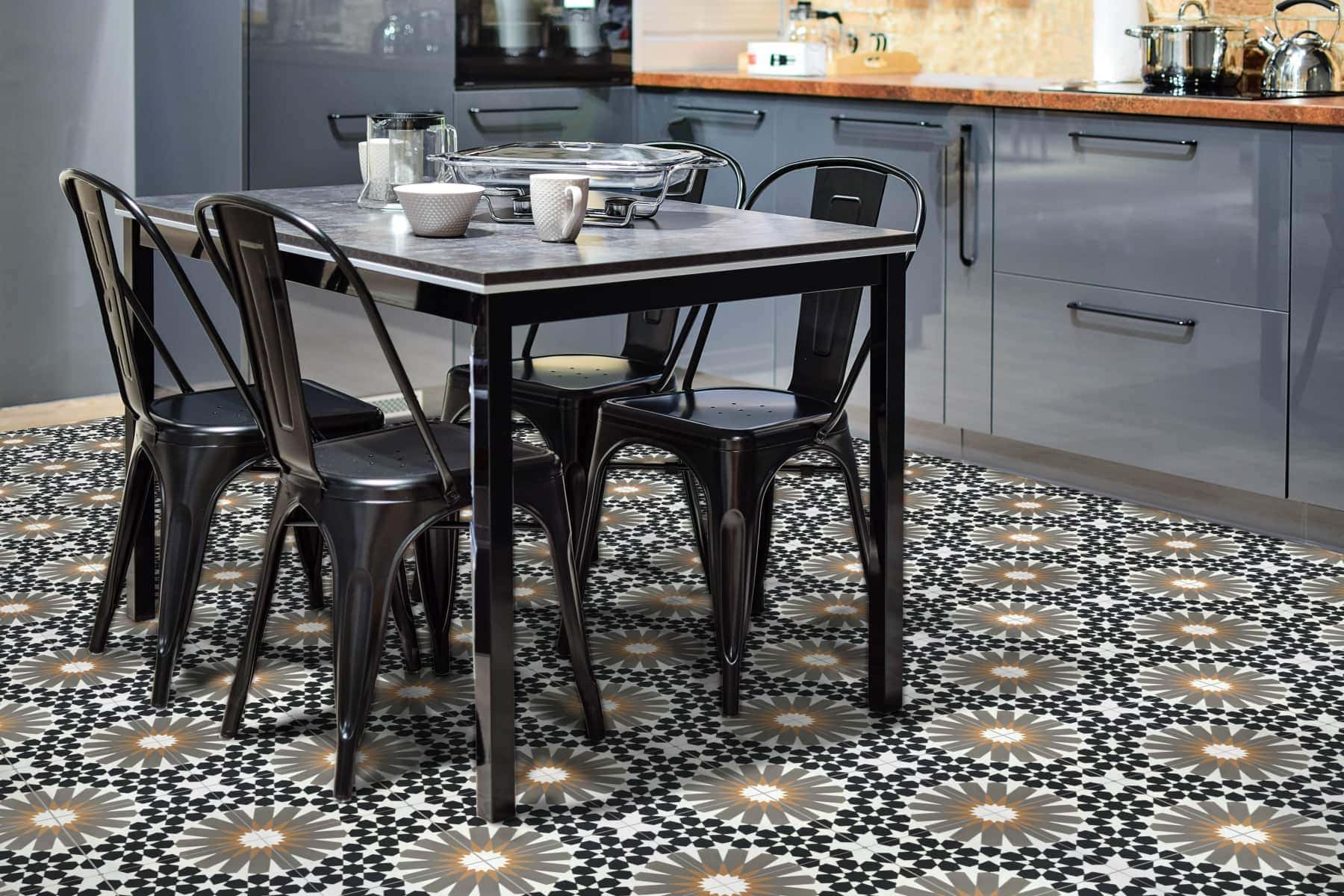 A stunning patterned floor using cement tiles in a kitchen