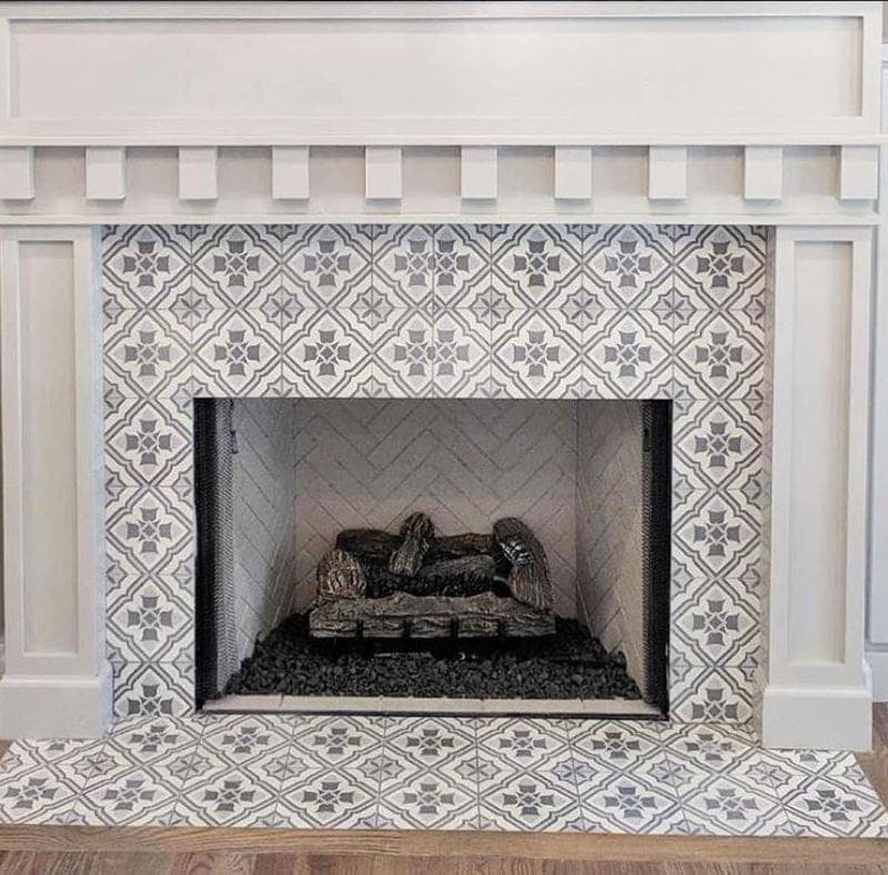 Beautiful cement tile surrounds a fireplace